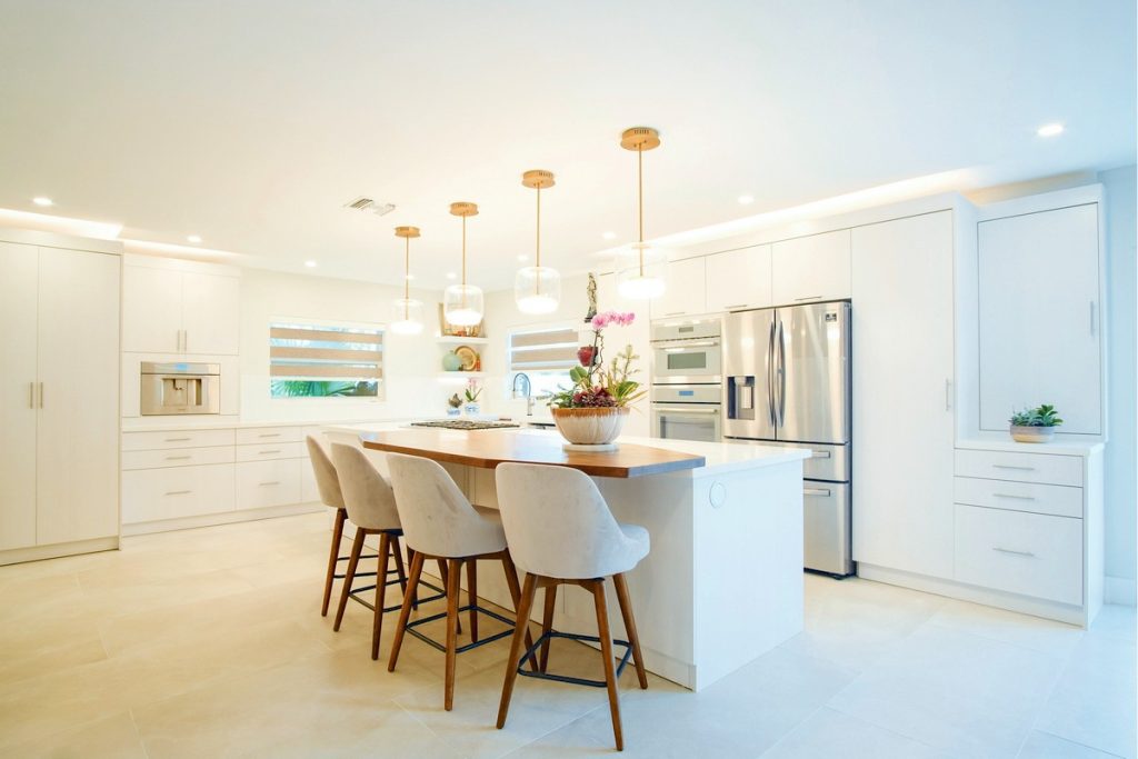 Transforming Premier Miami Contemporary Design - A minimalist, white kitchen