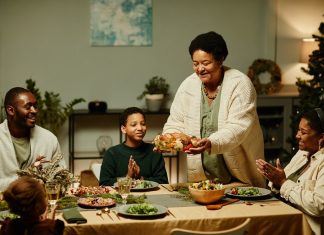 5 Unique Christmas Dinner Ideas - A family sitting down for Christmas dinner,