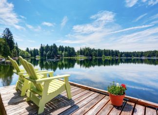4 Spectacular Additions for Your Waterfront Property An elegant, sophisticated wedding reception with reflective table tops, white flowers, and string lights over the ceiling.